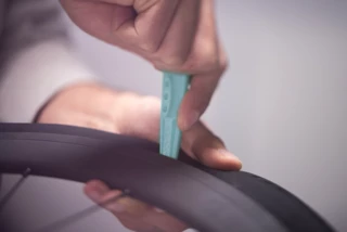 The tube is removed using a tire lever