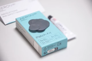 The contents of the AERON/TPU Patch Kit are laid out on a table